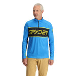 Spyder Men's Paramount 1/2 Zip Top - A blue top with a black stripe across the chest and yellow lettering that reads "SPYDER".