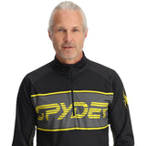 Spyder Men's Paramount 1/2 Zip Top 2025 - Black top with yellow and gray stripes on chest, zippered front.