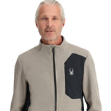 Spyder Men's Bandit Full-Zip Fleece Jacket 2025 - A tan fleece jacket with a black zipper and white logo on the left chest.