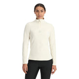 Spyder Women's Shimmer Bug 1/2 Zip Fleece 2025 - A woman wearing a white fleece top with a zipper and a small embroidered bug logo on the chest.