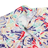 Spyder Girls' Reflect 1/2 Zip Top 2025 - A white top with a colorful abstract pattern of red, purple, green, and yellow shapes.