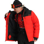 Spyder Bromont Insulated Jacket 2025 - A black jacket with a red and white logo on the left chest, featuring a hood and zippered pockets.