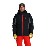 Spyder Vertex Insulated Jacket 2025 - A black jacket with a red zipper and logo on the left chest, worn by a model against a white background.