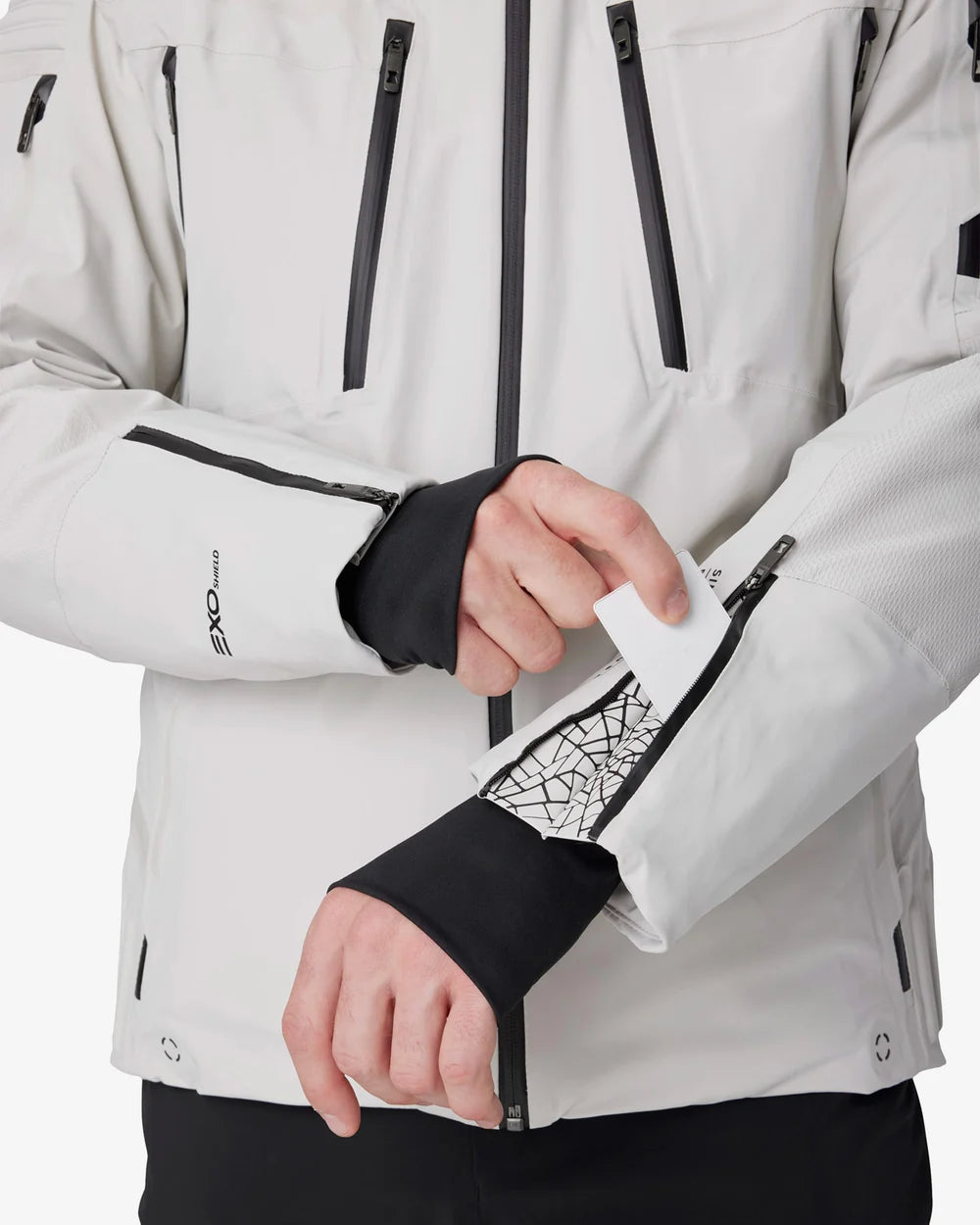Light grey insulated jacket with black cuff panels, front zippers, and utility pocket openings.