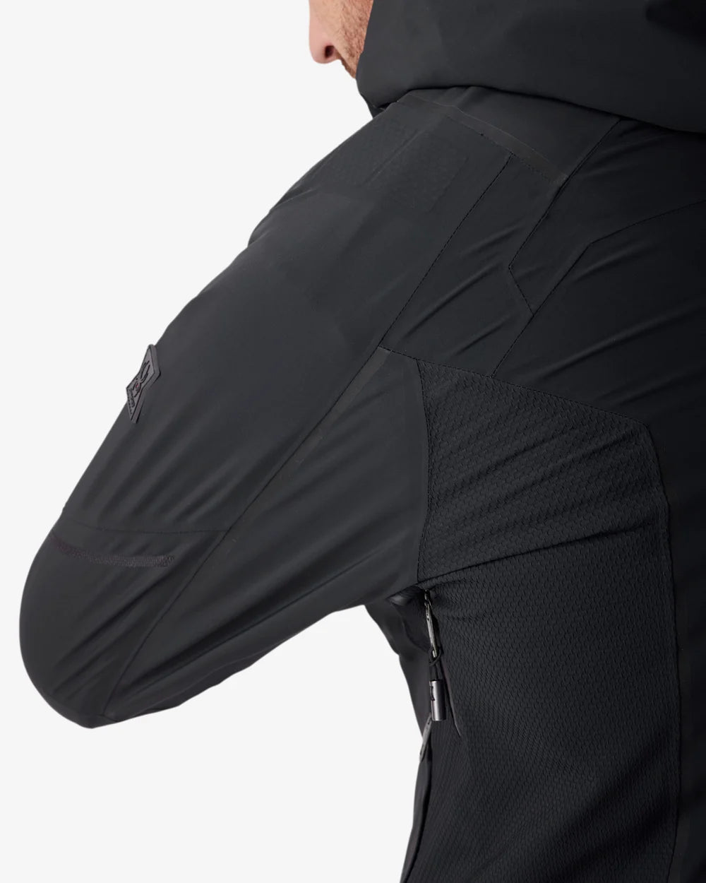 Black insulated jacket sleeve with textured side panel and small zipper detail