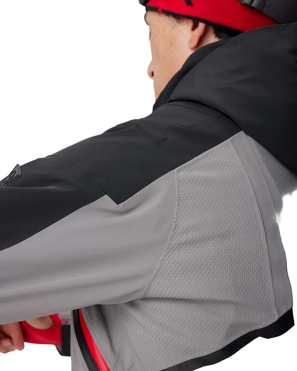 Insulated ski jacket sleeve close-up, gray fabric with black panel and textured underarm