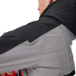 Insulated ski jacket sleeve close-up, gray fabric with black panel and textured underarm