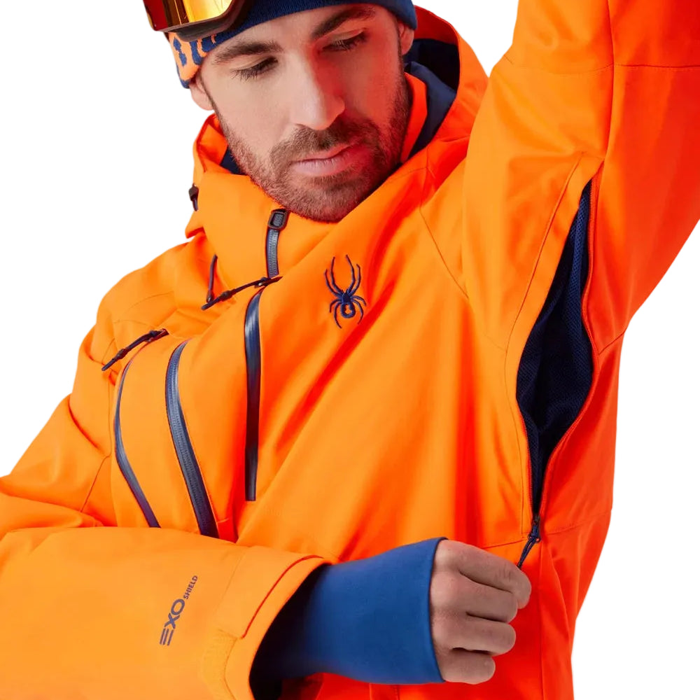 Spyder insulated ski jacket in bright orange with black hood lining and blue details