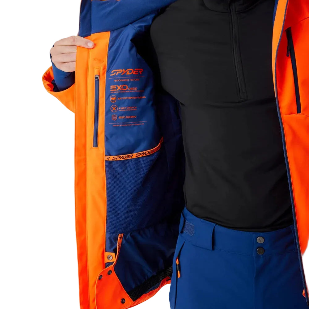 Spyder insulated ski jacket open front showing blue interior lining and orange trim