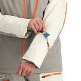 Spyder Leader Insulated Jacket - A man wearing a grey jacket with orange accents and a blue patterned zipper pull on the left sleeve.
