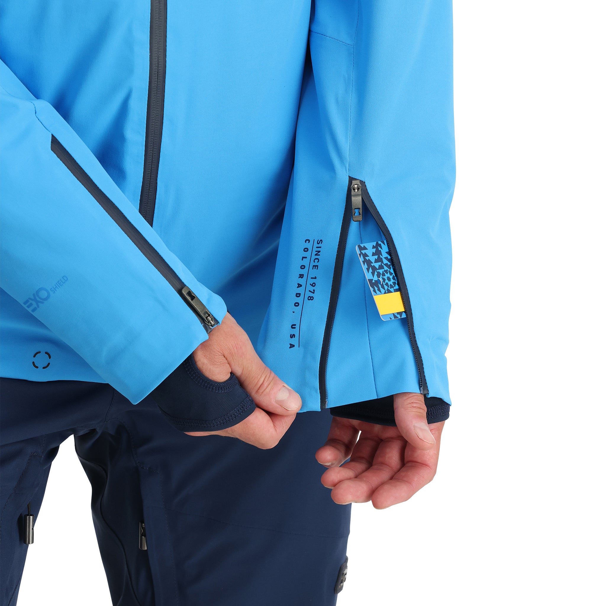 Spyder Pinnacle Insulated Jacket - A bright blue jacket with a black zipper and black trim on the hood, cuffs, and pockets.