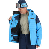 Spyder Pinnacle Insulated Jacket - A man wearing a light blue jacket with black accents and a high collar, holding it open to show the inside lining.