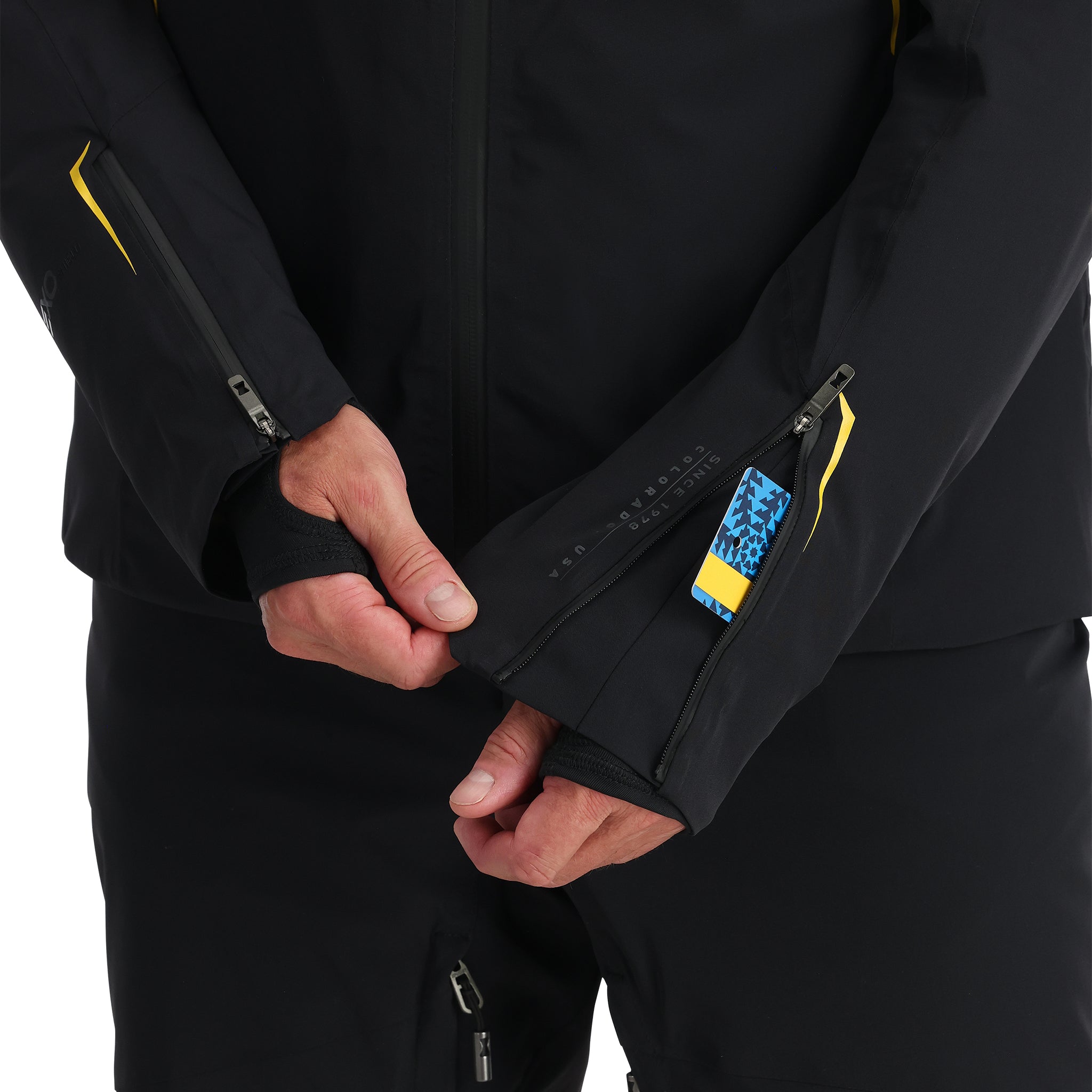 Spyder Monterosa Insulated Jacket - A black jacket with yellow accents on the shoulders and chest, featuring a zipper closure and two zippered pockets.