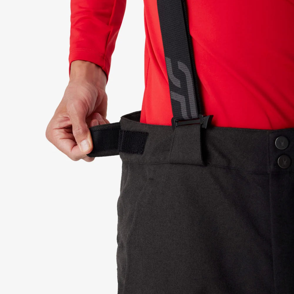 Insulated ski pants waistband detail with adjustable black strap and snap closure