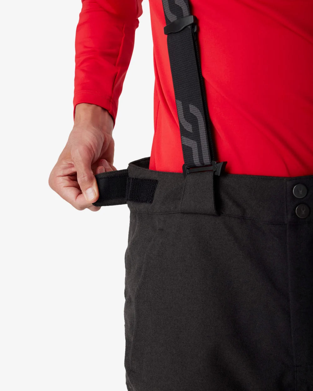Insulated ski pants waistband detail with adjustable black strap and snap closure