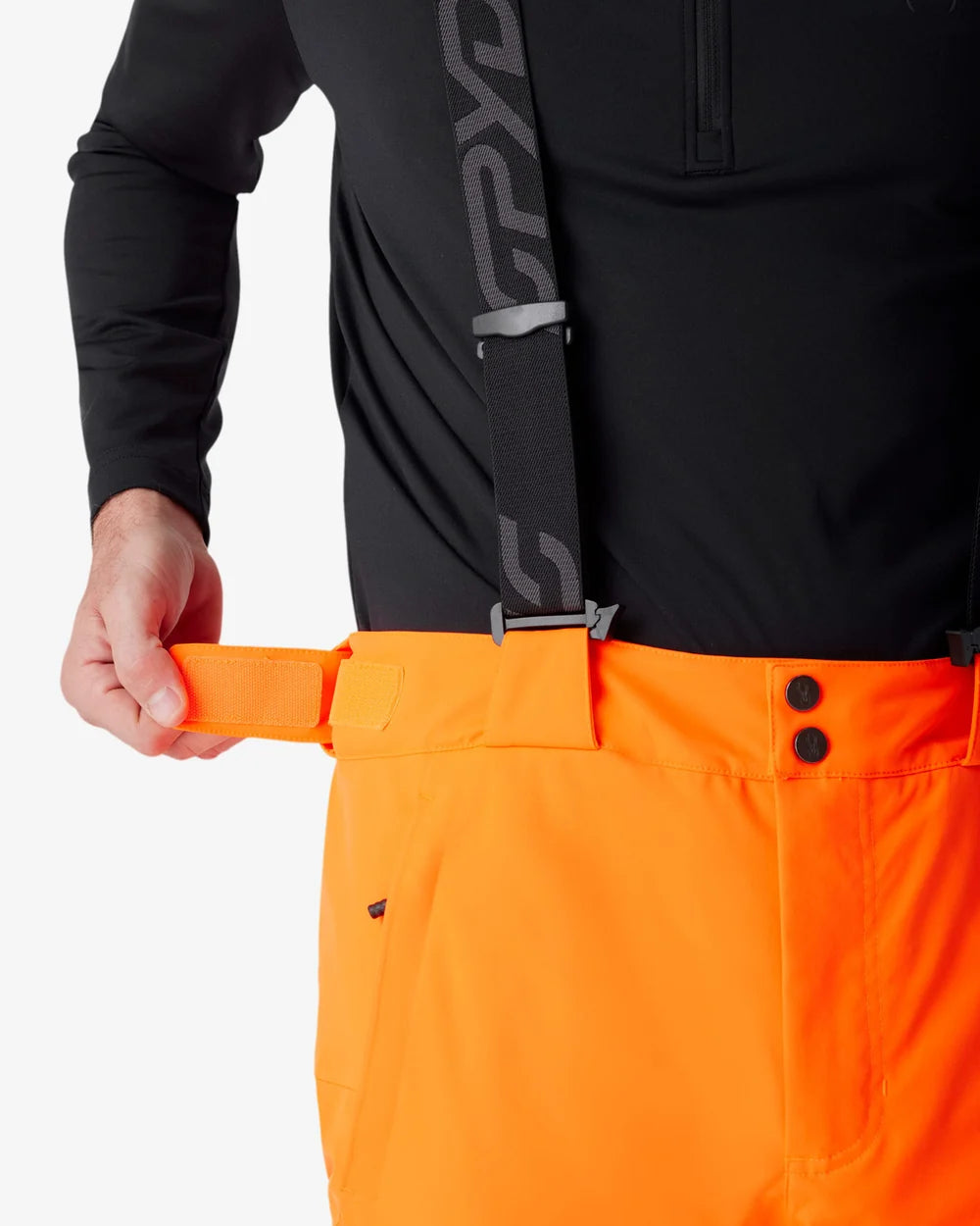 Insulated ski pants close-up: orange waistband with black belt loops and snap button