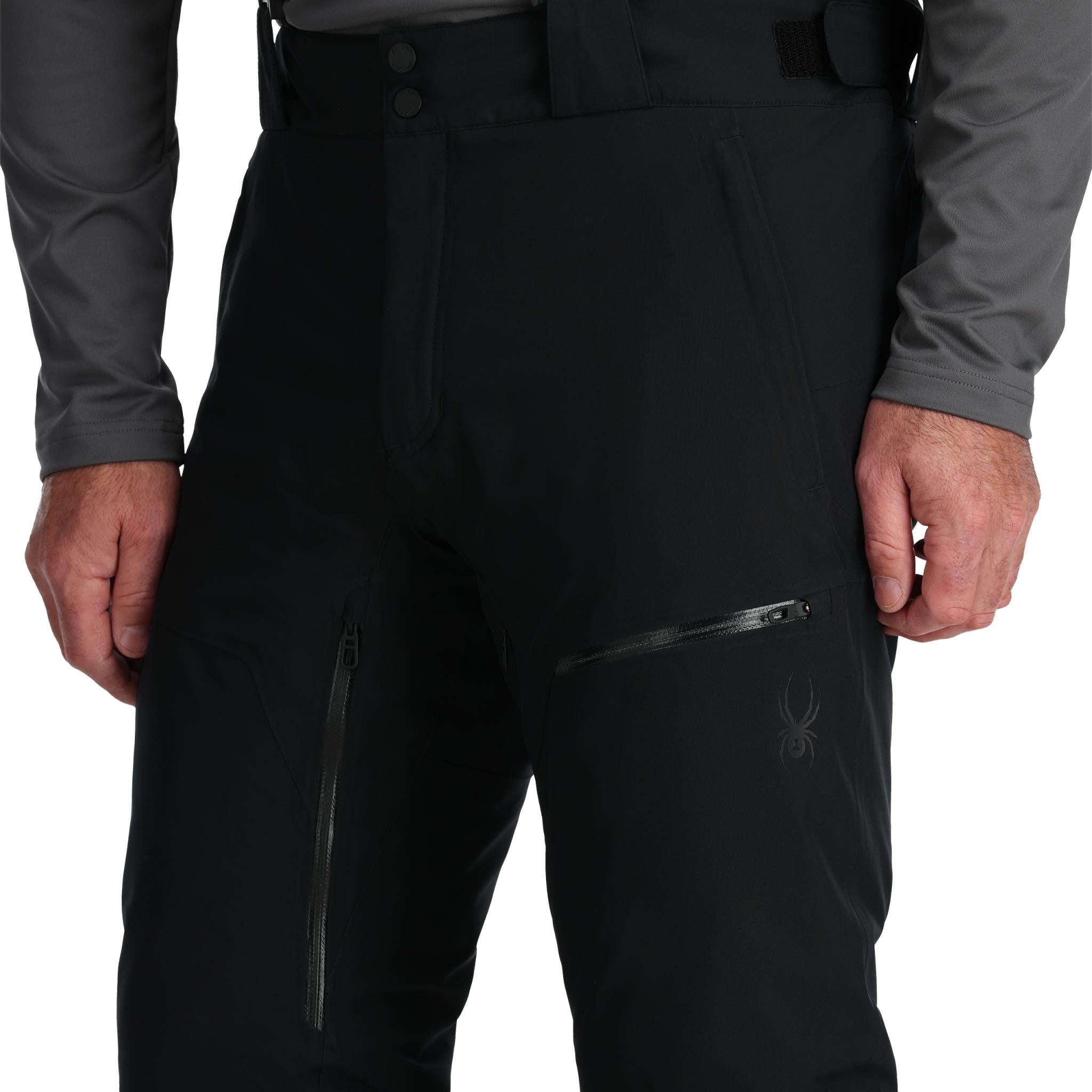 Spyder Men's Dare Insulated Pant Tall - Black pants with a subtle pattern of thin white lines on the upper thigh area.