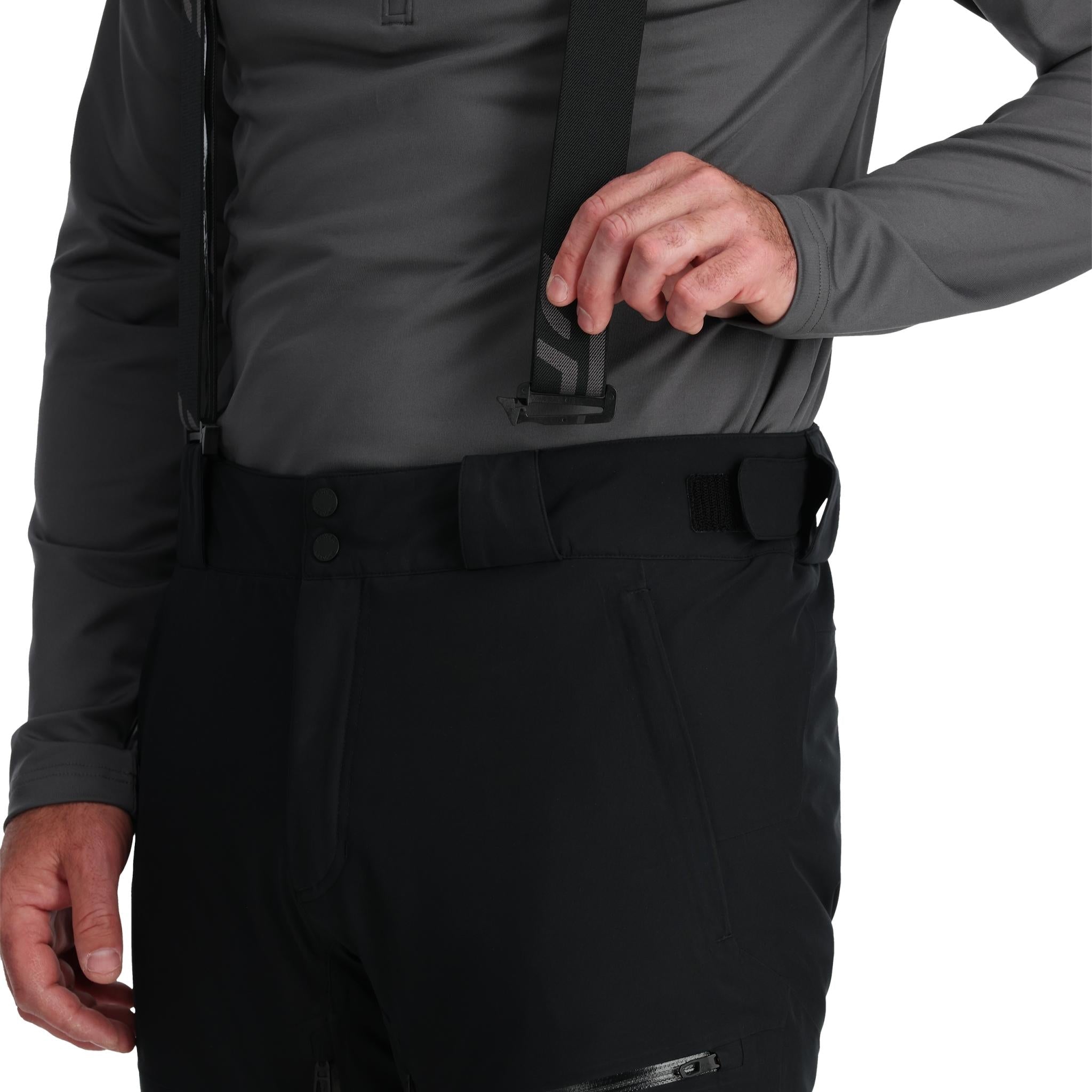 Spyder Men's Dare Insulated Pant Tall - Black pants with a subtle pattern of thin white lines on the left leg, and black hardware.
