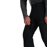 Spyder Men's Dare Insulated Pant Tall 2025 - Black ski pants with a zippered pocket on the right thigh and a black logo on the left leg.