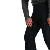 Spyder Men's Dare Insulated Pant Tall 2025 - Black ski pants with a zippered pocket on the right thigh and a black logo on the left leg.
