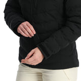 Spyder Women's Brisk Synthetic Down Jacket - A black jacket with a zippered chest pocket and two side pockets, featuring a hood and a fitted silhouette.
