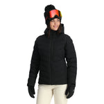 Spyder Women's Brisk Synthetic Down Jacket - A black down jacket with a high collar and zippered pockets, featuring a subtle logo on the left sleeve.