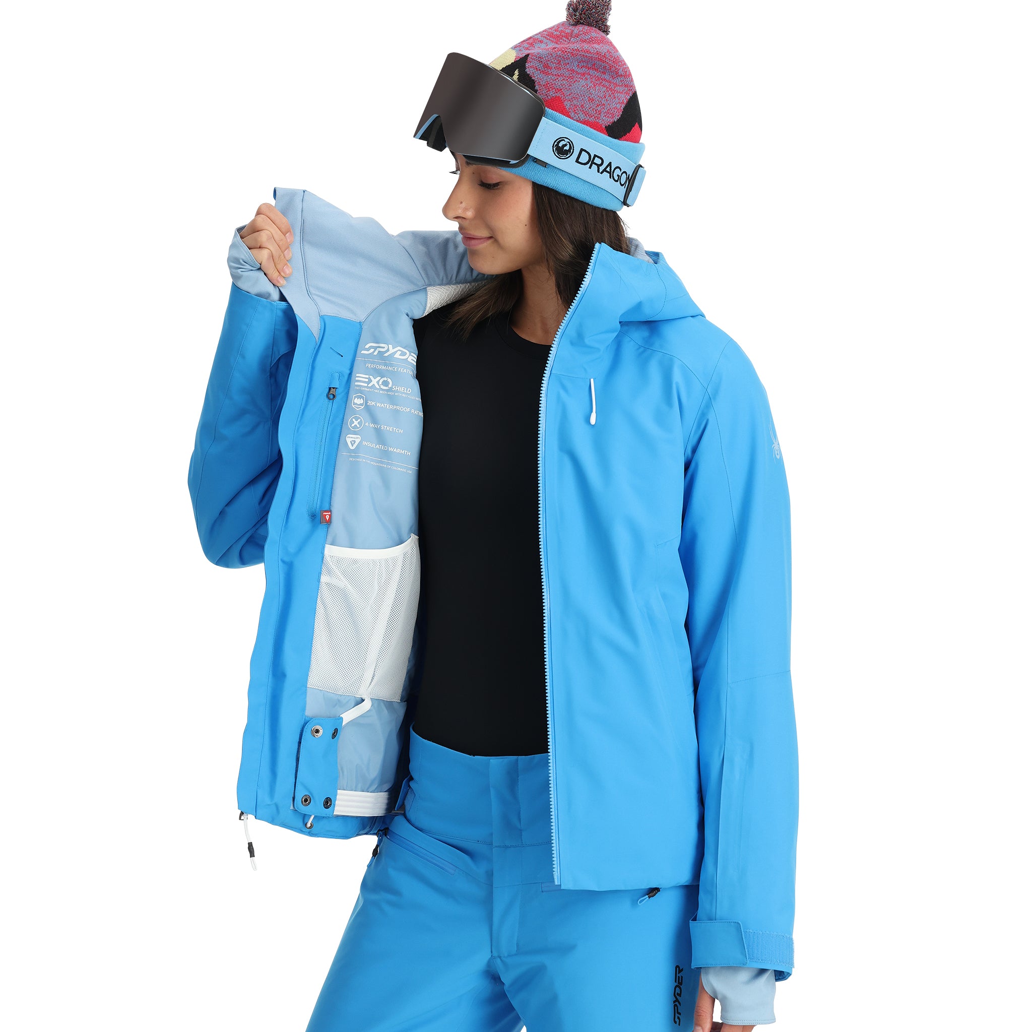 Spyder Women's Temerity Insulated Jacket - A light blue jacket with a white zipper and logo on the left chest, featuring a hood and two zippered pockets.