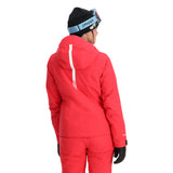Spyder Women's Temerity Insulated Jacket - A woman wearing a black beanie and ski goggles with light blue frames, looking to her right while modeling this jacket.