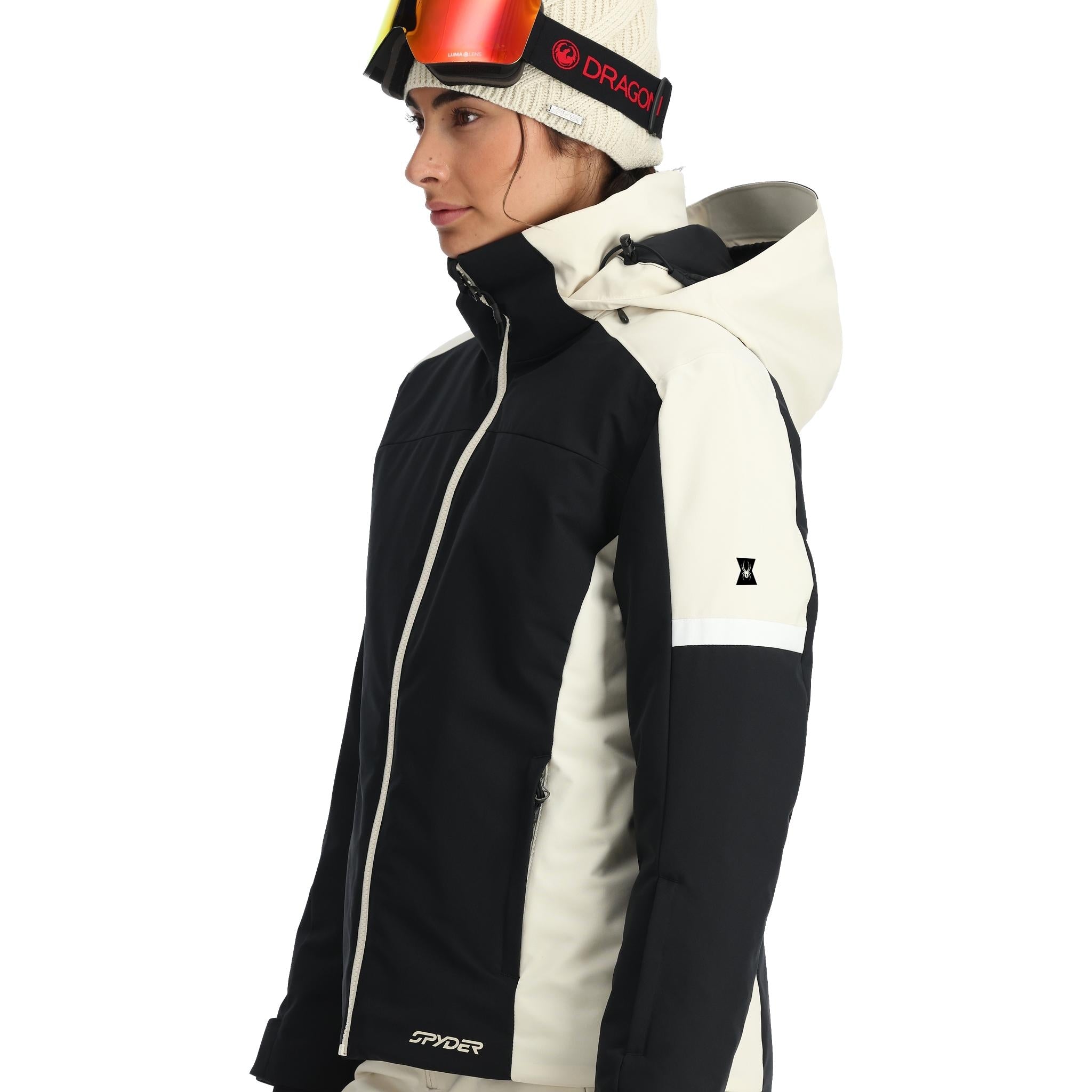 Spyder Women's Andorra Insulated Jacket 2025 - A black and white ski jacket with a zippered chest pocket, worn by a model on a plain background.