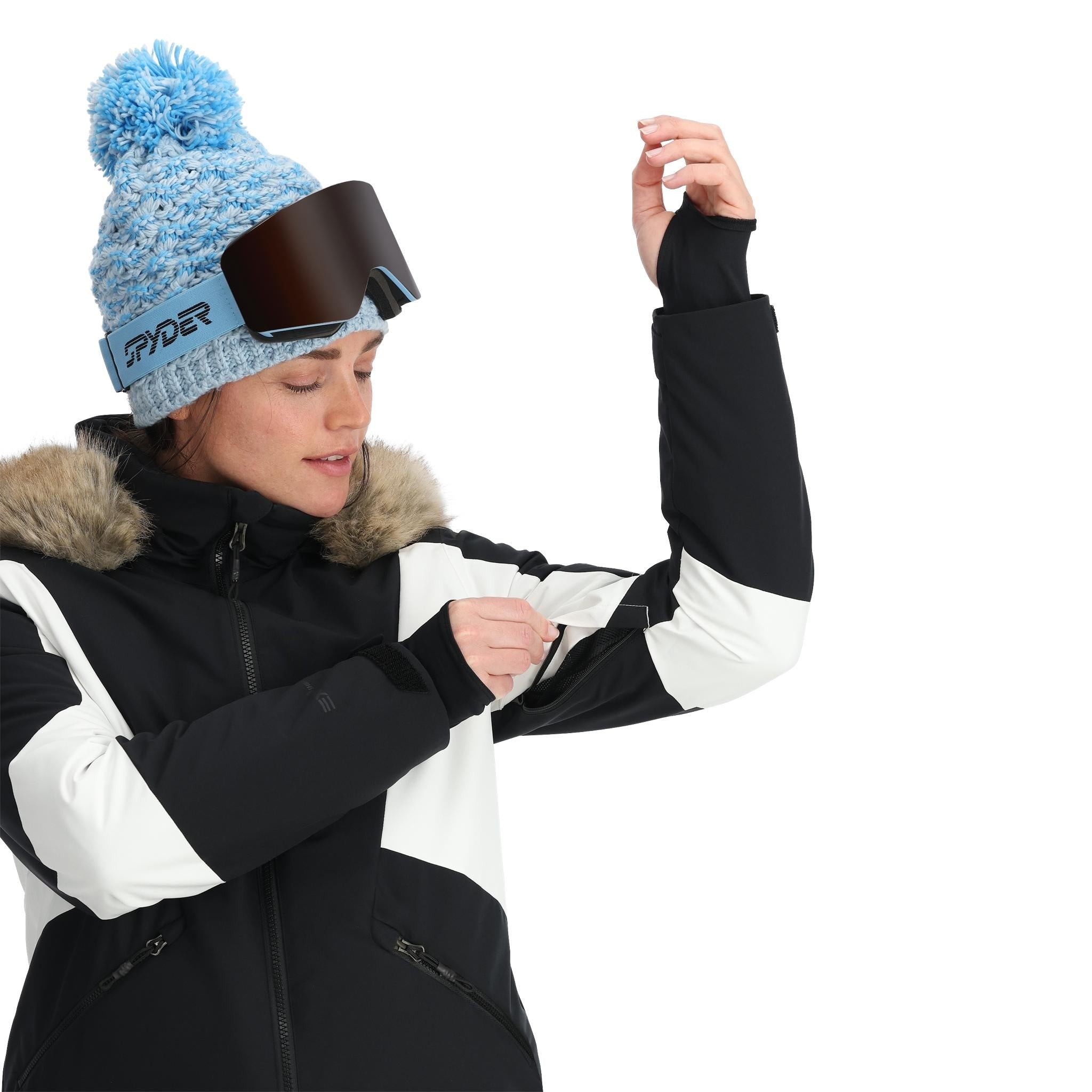 Spyder Women's Vida Insulated Faux Fur Jacket 2025 - A black and white jacket with a faux fur-lined hood, featuring a zippered front and two side pockets.
