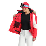 Spyder Women's Vida Insulated Faux Fur Jacket - A red and white jacket with a faux fur hood trim, featuring black accents on the shoulders and chest.