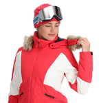 Spyder Women's Vida Insulated Faux Fur Jacket - A red and white jacket with a faux fur-lined hood, featuring a zipper closure and two zippered pockets on the front.