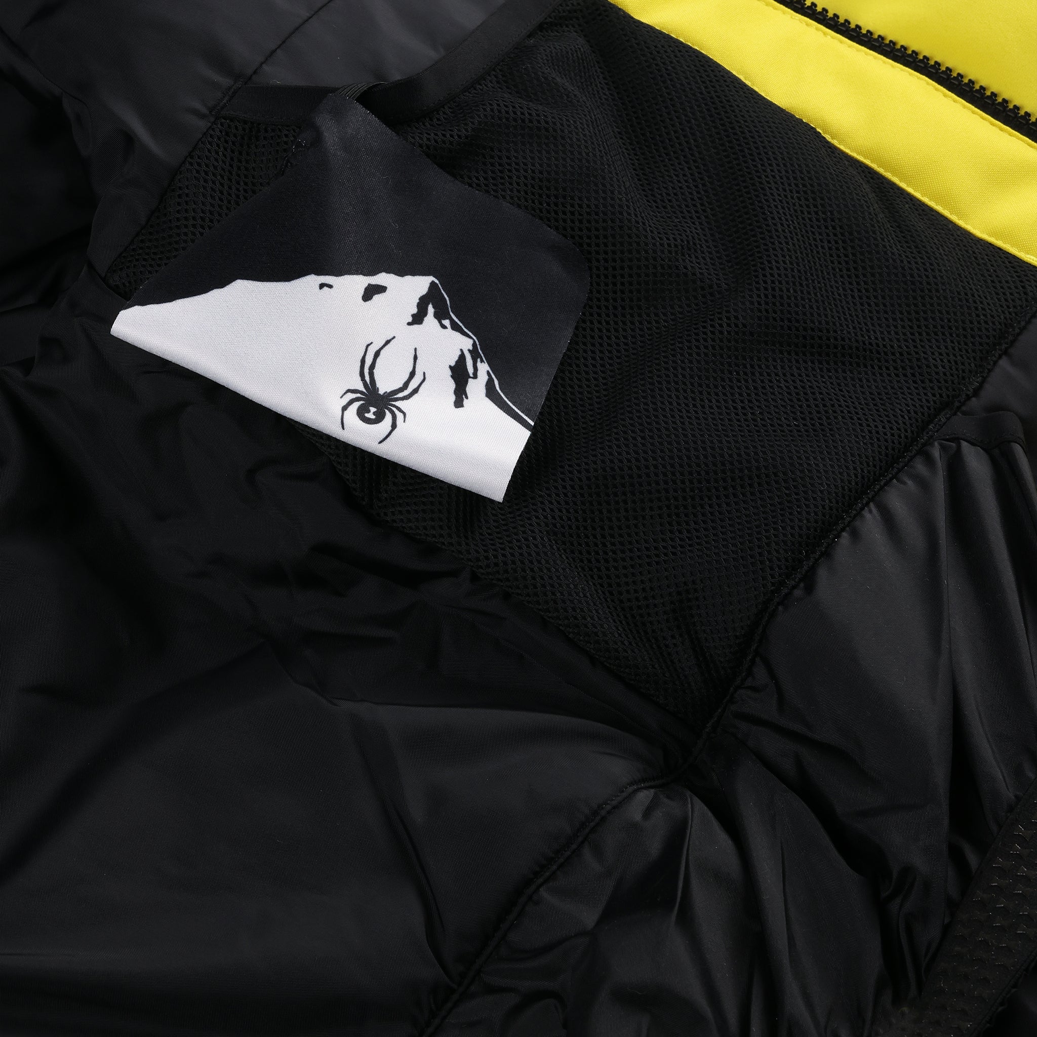 Spyder Boys' Leader Insulated Jacket 2025 - A black jacket with a white logo on the left chest and a yellow stripe down the right arm.