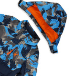 Spyder Boys' Impulse Synthetic Down Jacket 2025 - A blue and gray camouflage patterned jacket with a navy-blue zipper on the chest.