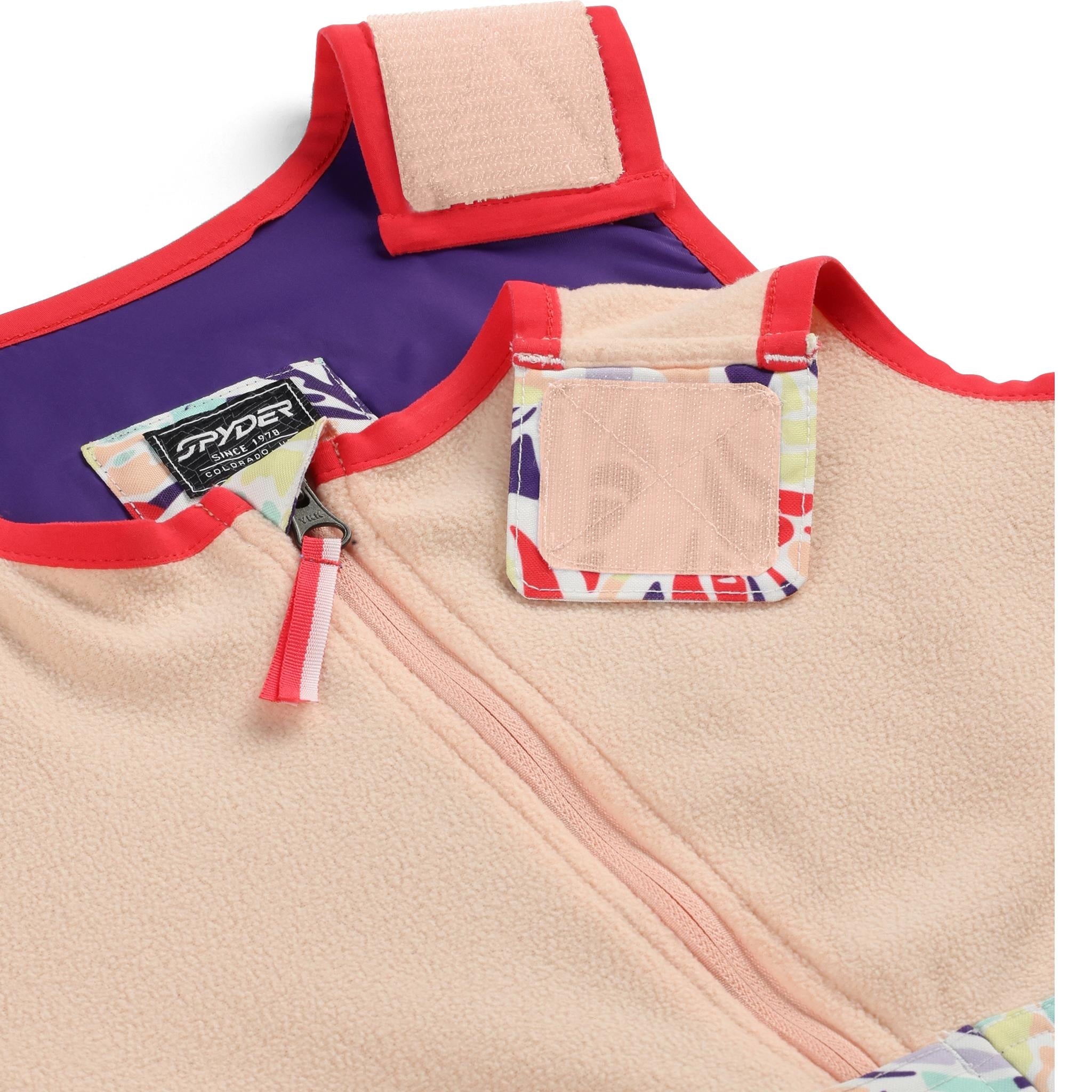 Spyder Girls' Expedition Insulated Bib Pant 2025 - A pair of insulated bib pants with a purple and white geometric pattern on the side, featuring a black Spyder logo.