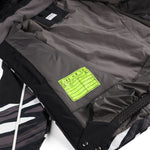 Spyder Youth Conquer Insulated Jacket 2025 - A black and white youth jacket with a camouflage pattern on the sleeves, featuring a zippered front and hood.