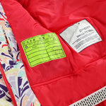 Spyder Youth Conquer Insulated Jacket 2025 - A vibrant red jacket with a subtle white pattern on the sleeve cuff and chest, featuring a zippered front and two pockets.