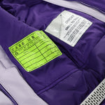Spyder Youth Conquer Insulated Jacket 2025 - A purple jacket with a white logo on the left chest and a zipper closure.