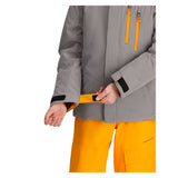 Obermeyer Junior's Insulated Gentleman's Jacket - A grey jacket with a black zipper and orange accents on the cuffs, worn by an unseen model.