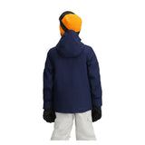 Obermeyer Junior's Insulated Gentleman's Jacket - A navy blue jacket with a hood, worn by a model from behind.
