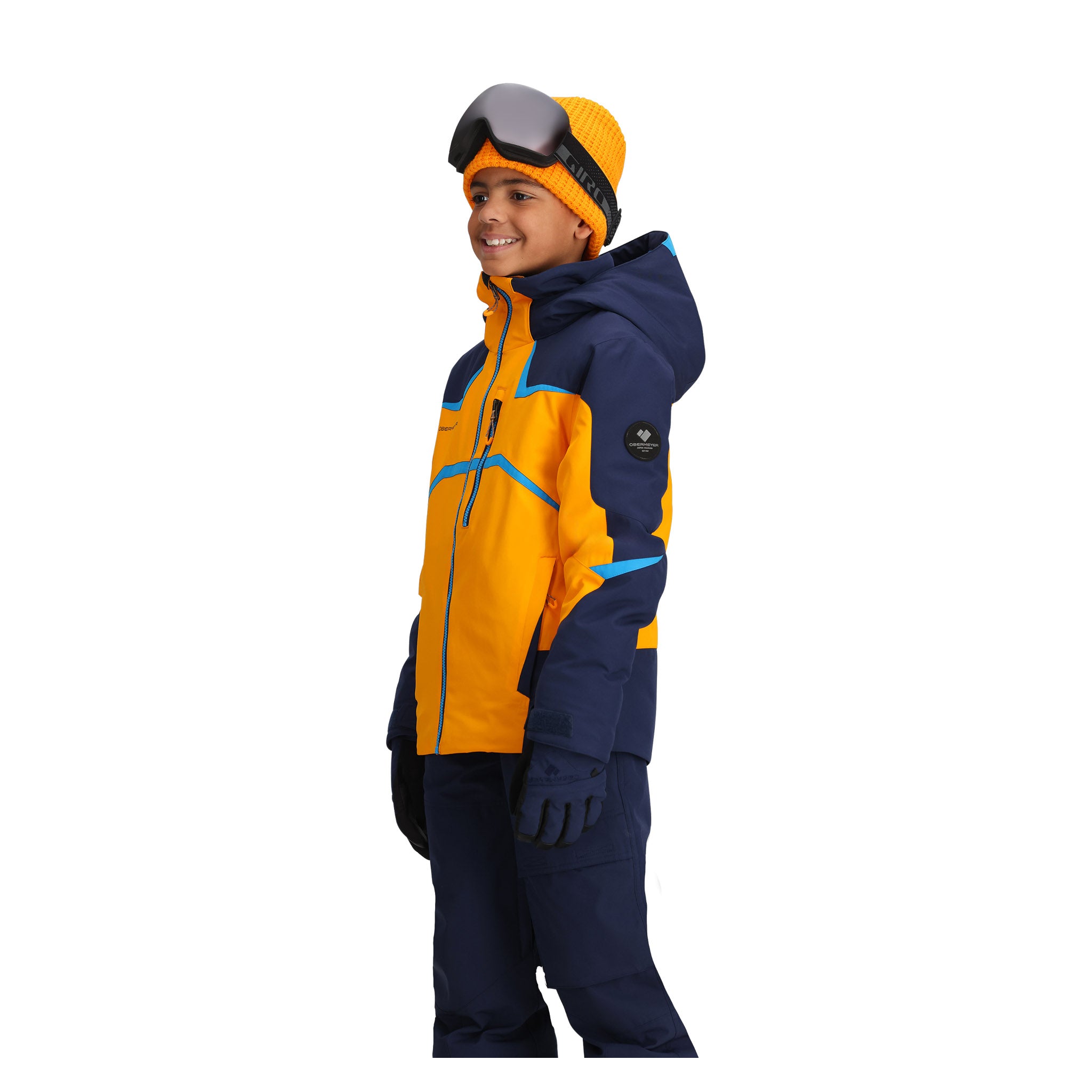 Obermeyer Juniors Mach 15 Insulated Jacket - A bright orange jacket with a navy blue hood and accents, featuring a zippered chest pocket and two side pockets.