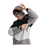Obermeyer Junior's Axel Insulated Jacket 2025 - A black and grey jacket with a white zipper on the chest, worn by a young boy looking down at his hands.