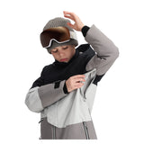 Obermeyer Junior's Axel Insulated Jacket 2025 - A black and grey jacket with a white zipper on the chest, worn by a young boy looking down at his hands.