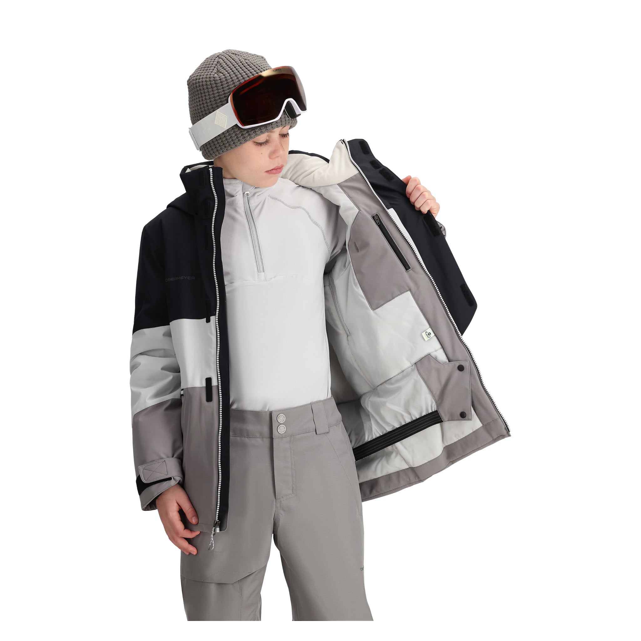 Obermeyer Junior's Axel Insulated Jacket 2025 - A black, white and grey snowboard jacket with a zippered chest pocket and two zippered side pockets.