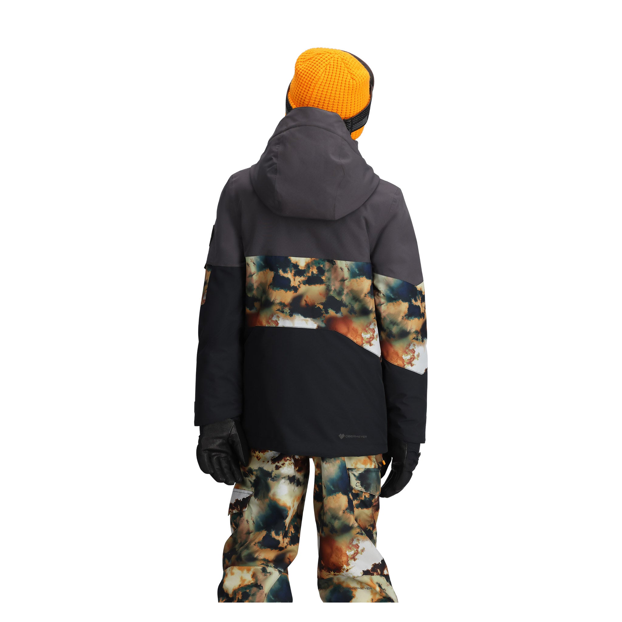 Obermeyer Junior's Axel Insulated Jacket 2025 - A black jacket with a hood, featuring a pattern of orange and white snowflakes on the chest and sleeves.