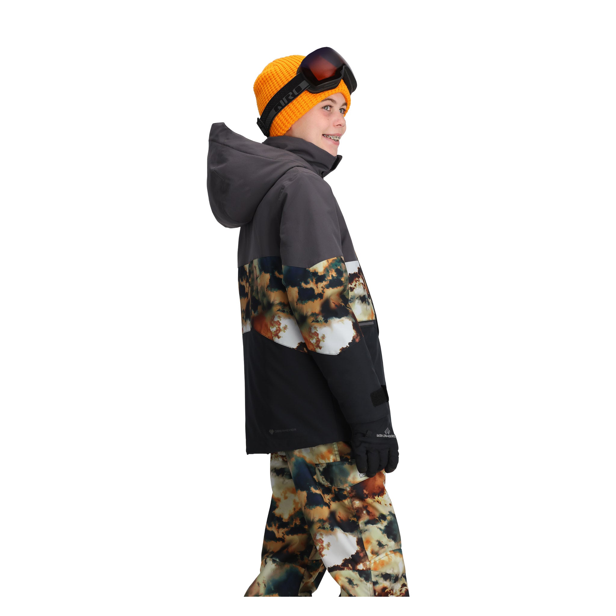Obermeyer Junior's Axel Insulated Jacket 2025 - A black jacket with a white and orange snowboarder graphic on the back, worn by a model.