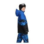 Obermeyer Junior's Axel Insulated Jacket 2025 - A blue and black insulated jacket with a hood, featuring a zippered front and two side pockets.