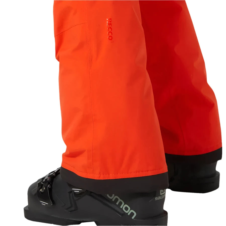 Helly Hansen Junior's Legendary Insulated Pant 2025 - A pair of bright orange snow pants with a black stripe down the side and a logo on the left leg.