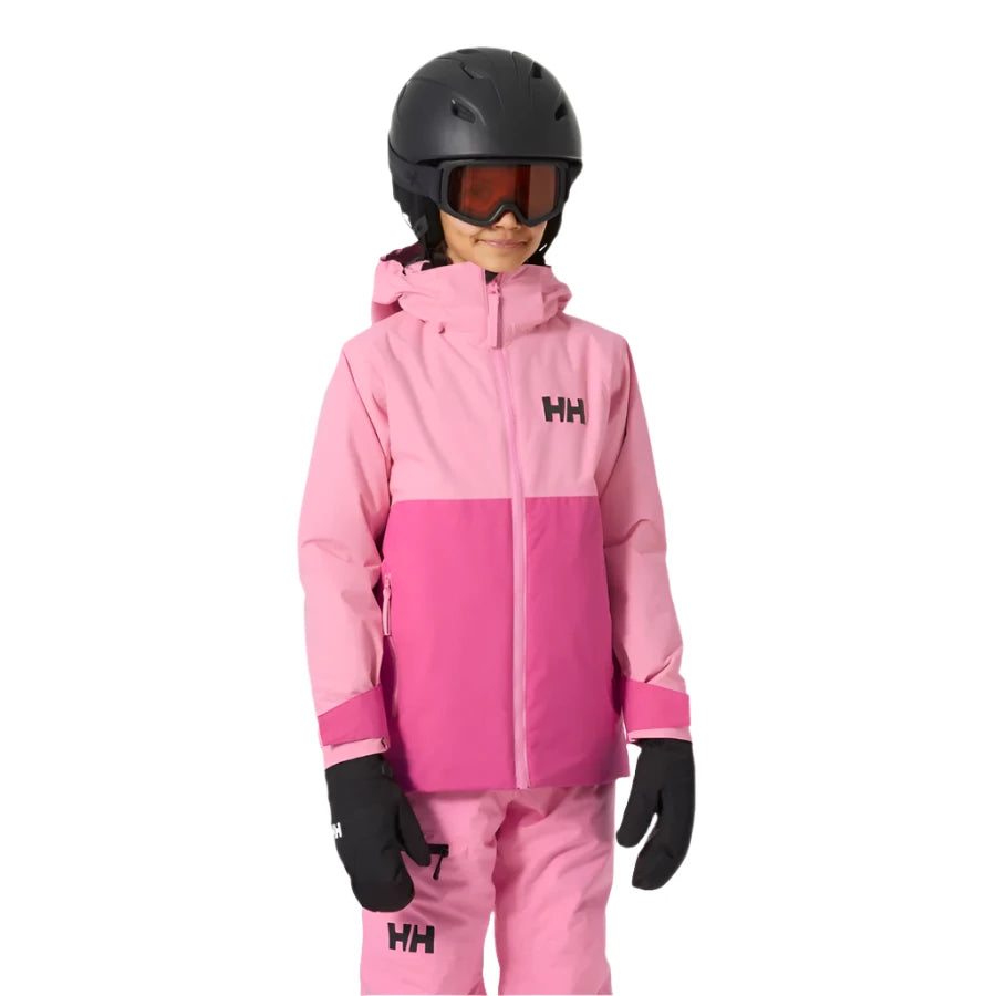 Helly Hansen Junior's Traverse Insulated Jacket 2025 - A young child wearing a pink and light-pink jacket with a hood, black gloves, and a black helmet.