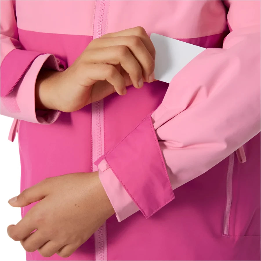 Helly Hansen Junior's Traverse Insulated Jacket - A pink insulated jacket with a hood, featuring a zipper and two pockets on the front.